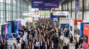 Thousands of digital marketing and technology professionals networking on the busy exhibition floor at DMEXCO 2026 inside the Koelnmesse halls in Cologne, Germany